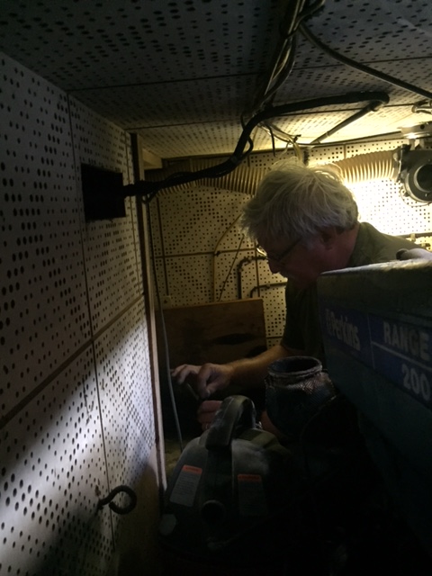 Bob in the engine room clearing out the space for batteries.